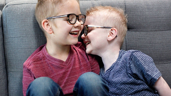 Two brothers need glasses, two different reasons.